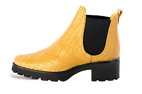 Mustard yellow and matt black women's ankle boots, with elastics. Round toe. Low rubber soles. Profile view - Florence KOOIJMAN